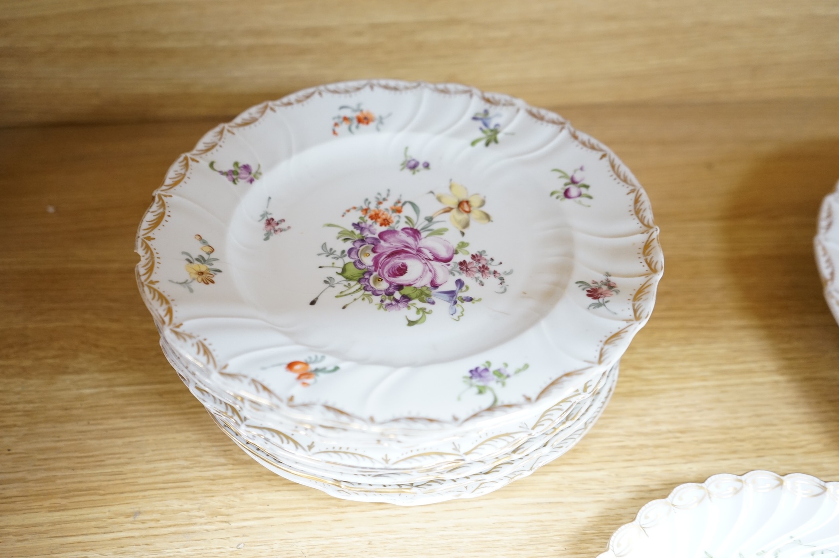Eleven Dresden porcelain floral decorated plates(various sizes) and similar plate, two largest 31cm diameter.